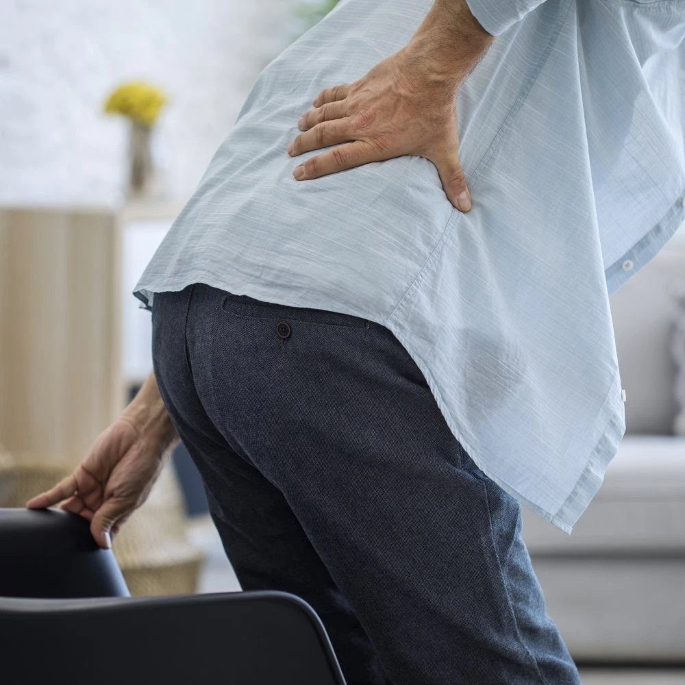 Man standing with back pain